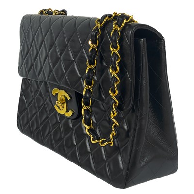 Lot 125 - A Chanel black lambskin jumbo maxi single flap bag.