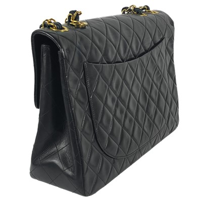 Lot 125 - A Chanel black lambskin jumbo maxi single flap bag.