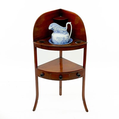 Lot 1828 - A George III mahogany corner washstand.