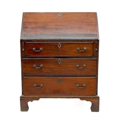 Lot 1827 - A mahogany and oak bureau.