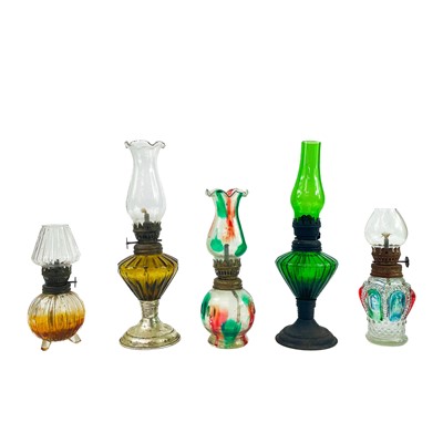 Lot 202 - A collection of small glass oil lamps.