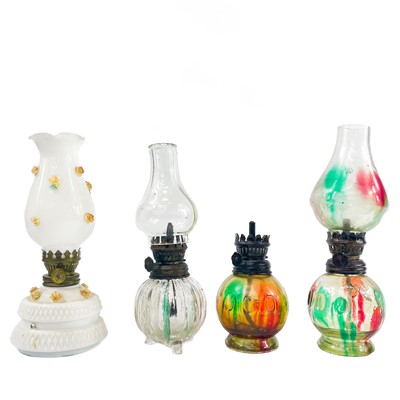 Lot 202 - A collection of small glass oil lamps.