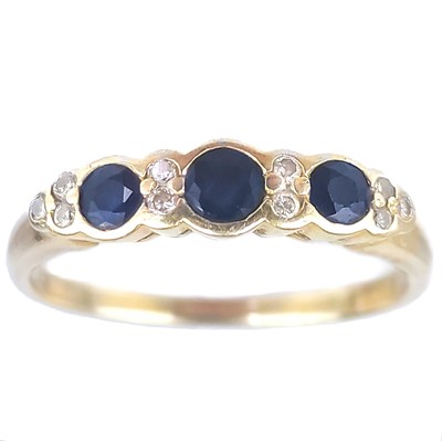 Lot 74 - A modern 18ct gold diamond and blue sapphire half eternity ring.