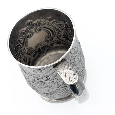 Lot 68 - An early George III silver embossed half pint mug by Thomas Whipham & Charles Wright.
