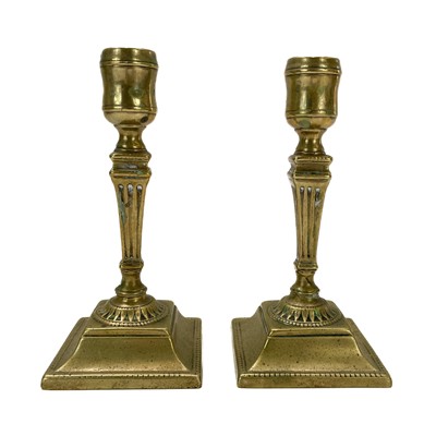 Lot 138 - A pair of Georgian brass candlesticks.